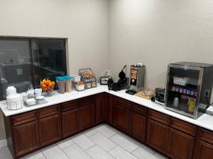 a kitchen with a counter with a coffee maker and a microwave at Super 8 by Wyndham Marion in Marion