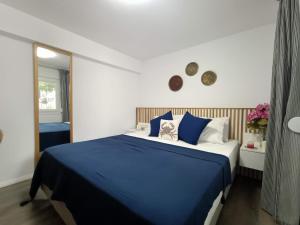 a bedroom with a blue and white bed and a window at Spitaki Apartments Potos in Potos