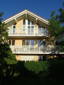 a large house with a balcony on the side of it at Ferienwohnung Findus in Haldenwang