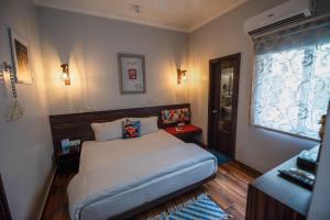 a small bedroom with a bed and a window at Stay Shaandaar a boutique hotel Amritsar in Amritsar