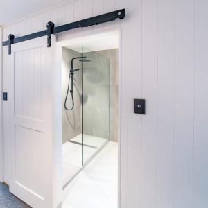 a shower with a glass door in a bathroom at Kamana Lakehouse in Queenstown