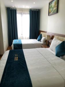 Postel nebo postele na pokoji v ubytování Noi Bai Boutique Hotel
