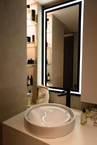 a sink in a bathroom with a large mirror at LUXURY FLAT WITH PRIVATE ROOFTOP - Paris 18 in Paris