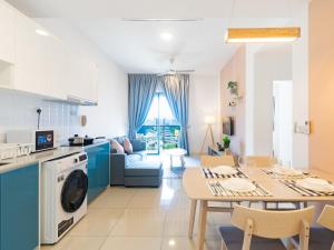 a kitchen and living room with a table and a dining room at Greystone Continew Residensi in Kuala Lumpur