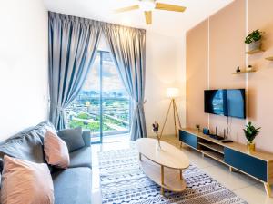 a living room with a couch and a tv at Greystone Continew Residensi in Kuala Lumpur