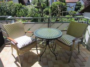 two chairs and a table on a patio at Haus Grete in Langenargen