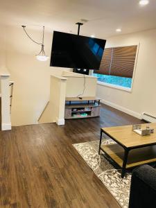 a living room with a large flat screen tv on the wall at Beautiful 2 bedroom 1 bath apartment with private garage in Anchorage