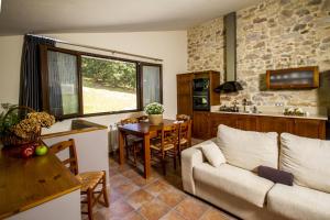 a living room with a couch and a table at Apartamentos Baolafuente in Rasines