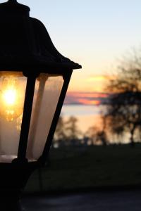 a street light with the sunset in the background at Crover Cottage Twin Room with Lake View in Mountnugent