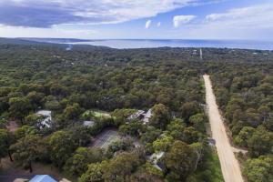 an aerial view of a road in the middle of a forest at Split Point Cottages in Aireys Inlet