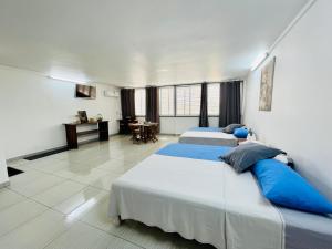 sypialnia z 2 łóżkami i stołem w obiekcie J&D Lodge w mieście Papeete