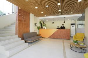 a lobby with two people sitting at a counter at Travelbee Airport Inn in Mactan