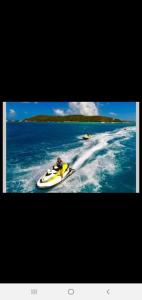 a person on a boat in the water at Sea breeze vacation lll en Condominio Verde mar in San Juan