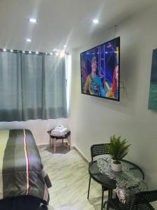 a living room with a tv hanging on the wall at Sea breeze vacation lll en Condominio Verde mar in San Juan