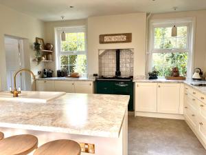 a kitchen with a sink and a counter top at Highview House Norfolk Coast - seaviews, beach, hot tub in Mundesley