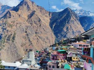 a view of a town in front of a mountain at Odyssey Stays Joshimath - Near Narsingh Temple in Joshīmath