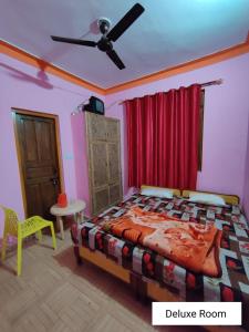 a bedroom with a bed and a ceiling fan at Odyssey Stays Joshimath - Near Narsingh Temple in Joshīmath