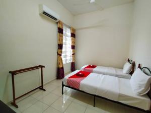 a bedroom with a bed and a window with curtains at D' Anjung Inn in Tangkak