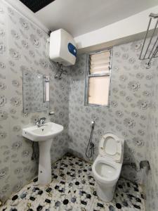 a bathroom with a toilet and a sink at Matina Regency in Gangtok