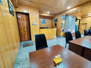 a conference room with wooden walls and tables and chairs at Matina Regency in Gangtok