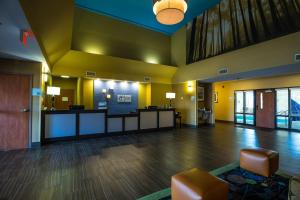 an empty lobby with a waiting area in a hospital at Holiday Inn Express Hotel & Suites Edmond, an IHG Hotel in Edmond