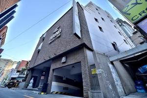 a building on the side of a street at Seomyeon Hound Hotel 1st Street in Busan