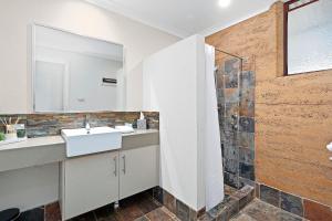 a bathroom with a sink and a shower at Grasstree Cottage - Woodstone Estate in Dunsborough
