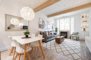 a living room with a table and a couch at Designer Cozy Ski in and out in Whistler