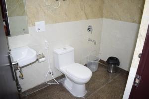 a bathroom with a white toilet and a sink at The Starling BnB in Greater Noida