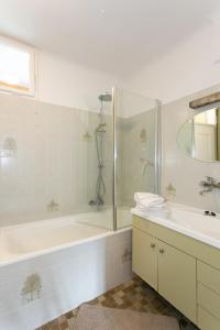 a bathroom with a shower and a tub and a sink at Familienglück in der Weststeiermark in Sankt Oswald ob Eibiswald +9 photos