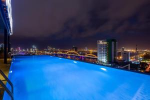 a swimming pool on the roof of a building at night at Val Soleil Hotel in Da Nang
