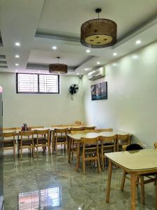 a dining room with wooden tables and chairs at Noi Bai Boutique Hotel in Hanoi