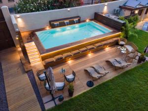 an overhead view of a swimming pool with chairs and a table at Bastione Spasimo Boutique Hotel in Palermo