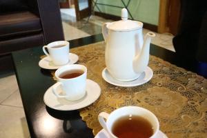 two cups of tea and a tea pot on a table at Prabu Villa Langenastran in Timuran