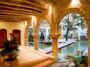 a swimming pool in a building with a swimming pool at Casa Pombo Luxury 3 largeBR Duplex old city 300m2 in Cartagena de Indias