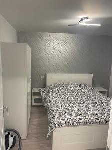 a bedroom with a bed with a black and white comforter at Apartament incantator in Roman in Roman