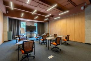 a conference room with tables and chairs and a tv at Sadu Hotel Almaty, a member of Radisson Individuals in Almaty +106 photos
