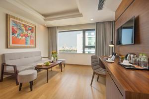 a living room with a couch and a table at Val Soleil Hotel in Da Nang