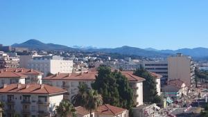 a city with buildings and mountains in the background at Nice Promenade des Anglais in Nice