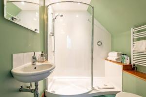 a bathroom with a sink and a shower at Stunning Luxury Duplex with Hot Tub and AirCon in Glenfarg