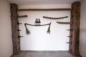 a room with two logs and three axes on the wall at Vineyard cottage Sonce in Šentvid pri Stični