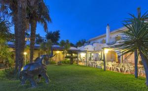 a statue of a bull in the yard of a house at Hotel Belsole in Ischia