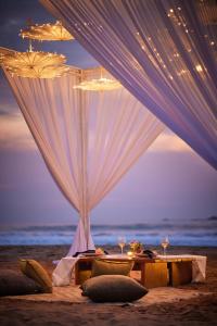 a dinner table on the beach at night at Cinnamon Bentota Beach - Signature Selection in Bentota