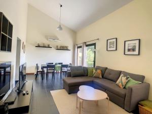 ein Wohnzimmer mit einem Sofa und einem Tisch in der Unterkunft Hillside House by LovelyStay in Achadas da Cruz