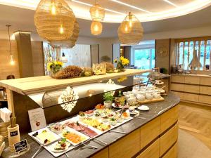 a buffet line with many different types of food at Hotel Garni & Appartementhaus Fichtenwald in Bad Füssing