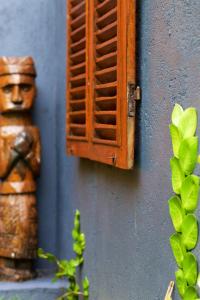 a wall with a statue and a vent on it at The Hidden Escapes Manggis- Stunning Tiny Home set on a Lake with Mountain View, Private Sauna, Pool, Bicycles, BBQ & Butler! in Padangbai