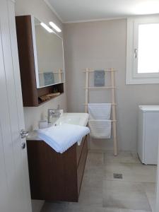 a bathroom with a sink and a mirror at Stilvi Milos in Plaka Milou