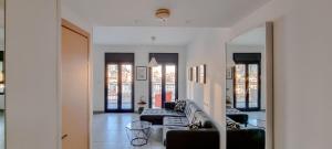 a living room with couches and chairs in a building at BnBIsrael apartments - Markolet Camelia in Tel Aviv