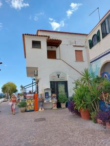 a woman walking in front of a building at Luna Blu in Erchie