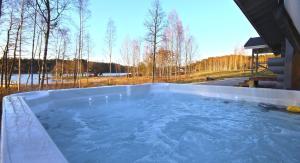 a large tub filled with blue water in a yard at Kuusiston majatalo in Kuusisto +4 photos